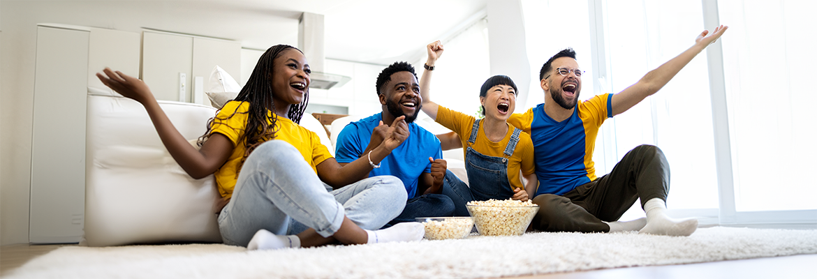 group of people watching live sports and celebrating