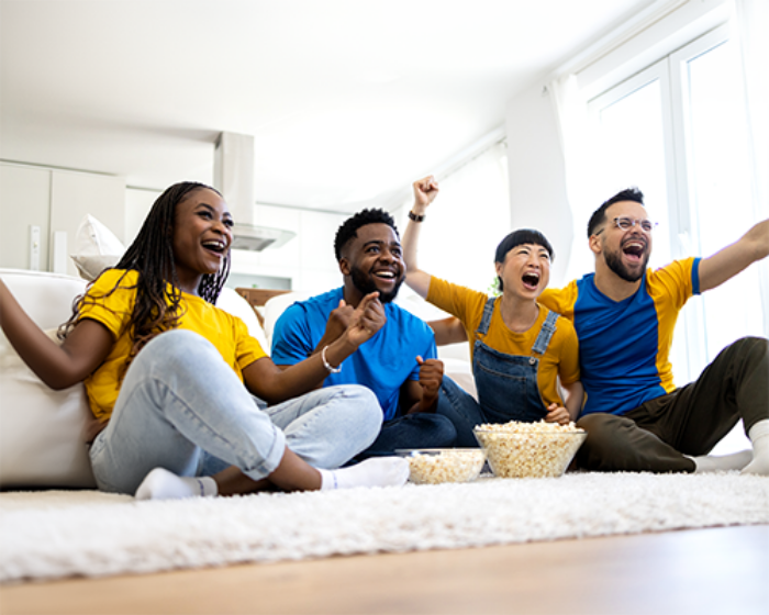 group of people watching live sports and celebrating